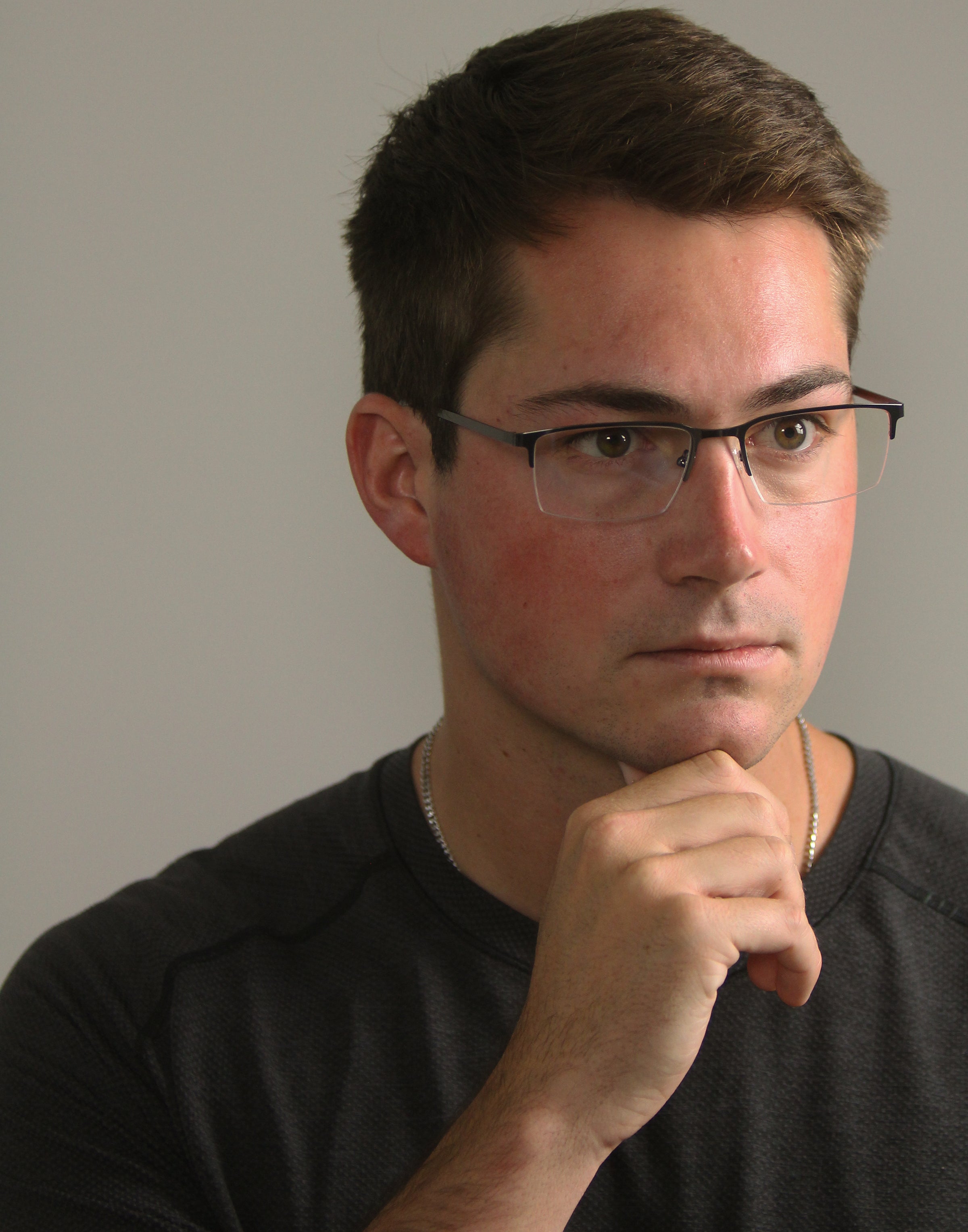 Man wearing glasses with a neutral background