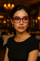 Woman wearing red glasses in a dimly lit indoor setting